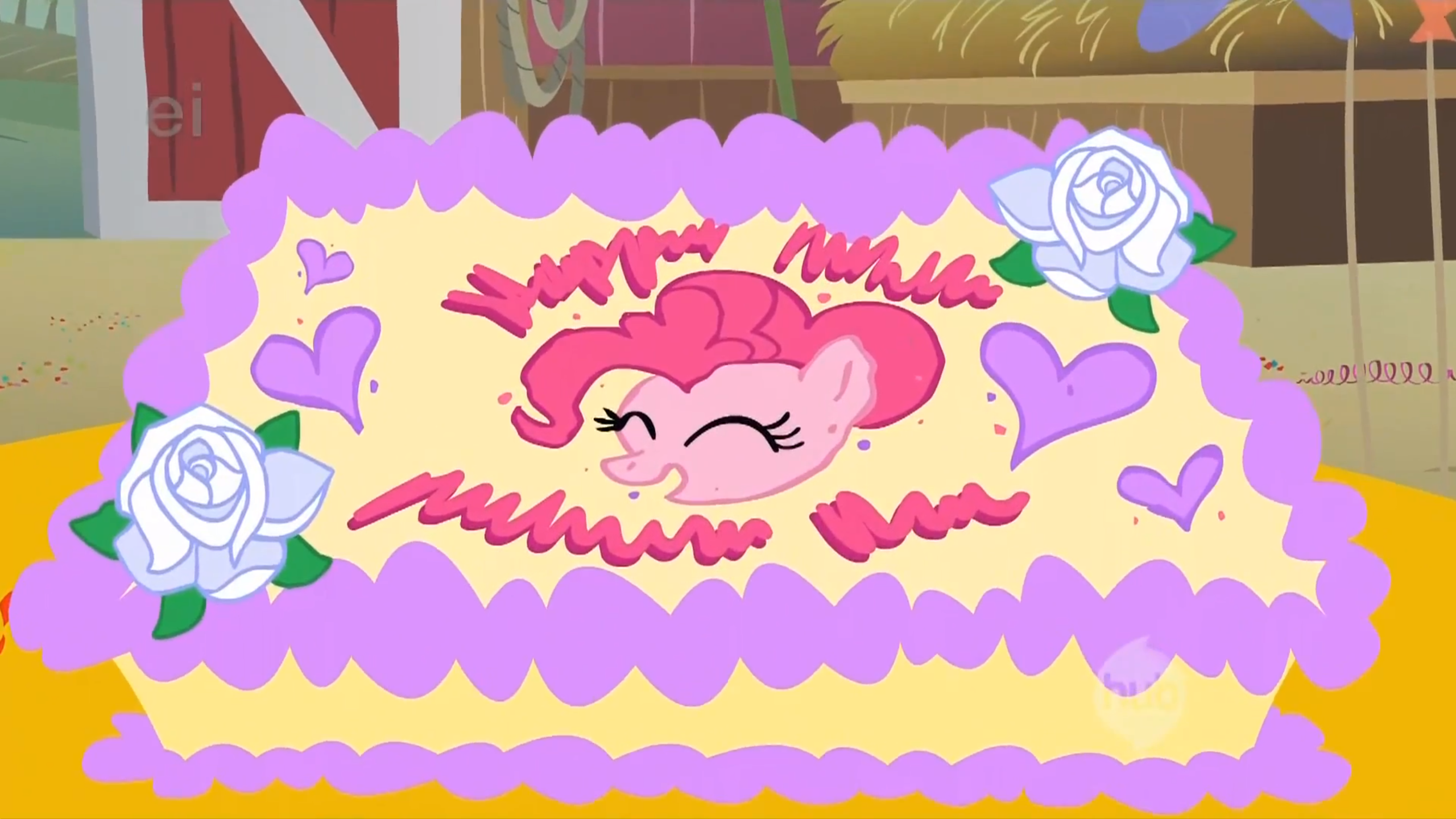 A large, rectangular cake, decorated with two white roses, a purple border, several purple hearts and a portrait of Pinkie Pie's face.