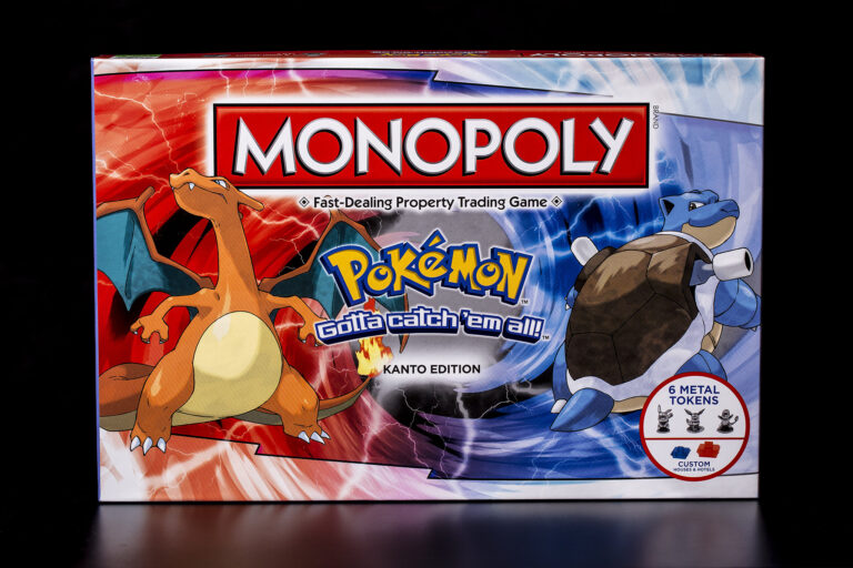 The box front cover for Monopoly Pokémon: Kanto Edition. The cover is half red and half blue, with Charizard and Blastoise depicted in each half.